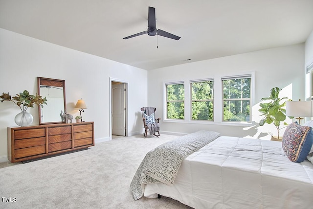 bedroom with multiple windows, carpet floors, baseboards, and ceiling fan