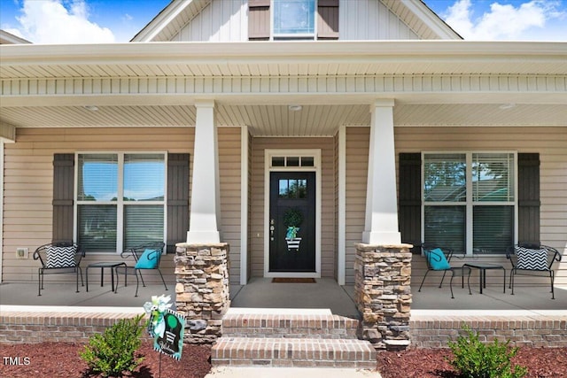 doorway to property featuring covered porch and board and batten siding