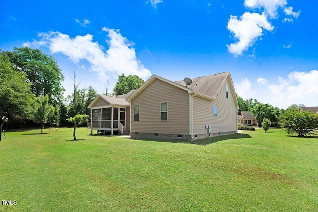 back of property featuring a sunroom, a yard, and crawl space