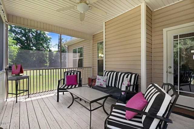 wooden terrace featuring a ceiling fan and an outdoor hangout area