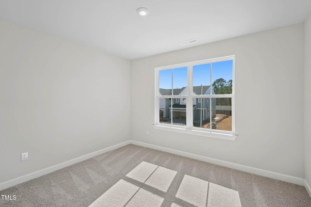 unfurnished room with baseboards and carpet floors