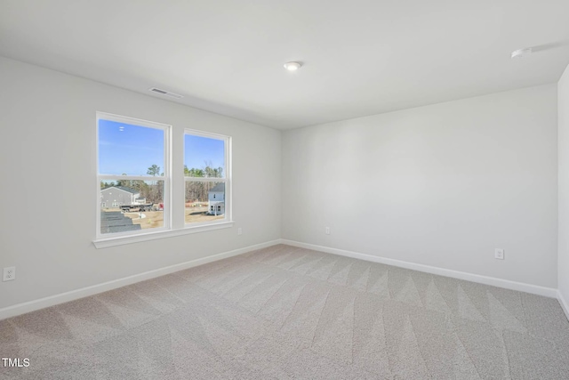 empty room with light carpet and baseboards