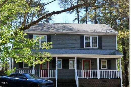view of front of property featuring a porch and a shingled roof