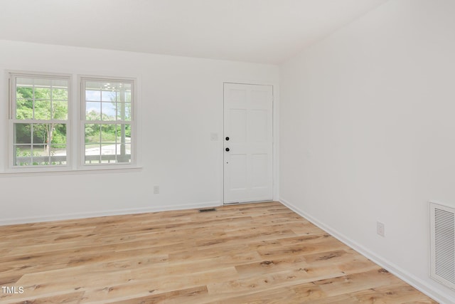 unfurnished room with light wood-style floors and baseboards