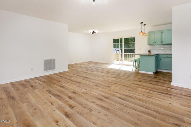 unfurnished living room with light wood-style floors and baseboards