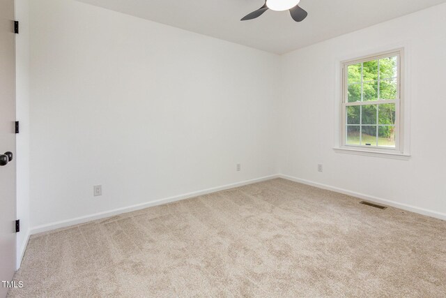 unfurnished room featuring carpet floors, ceiling fan, and baseboards