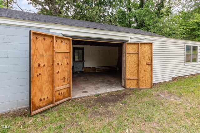view of outbuilding with a garage and an outbuilding