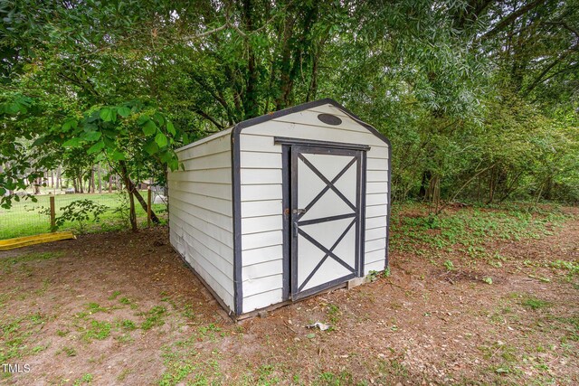 view of shed with fence
