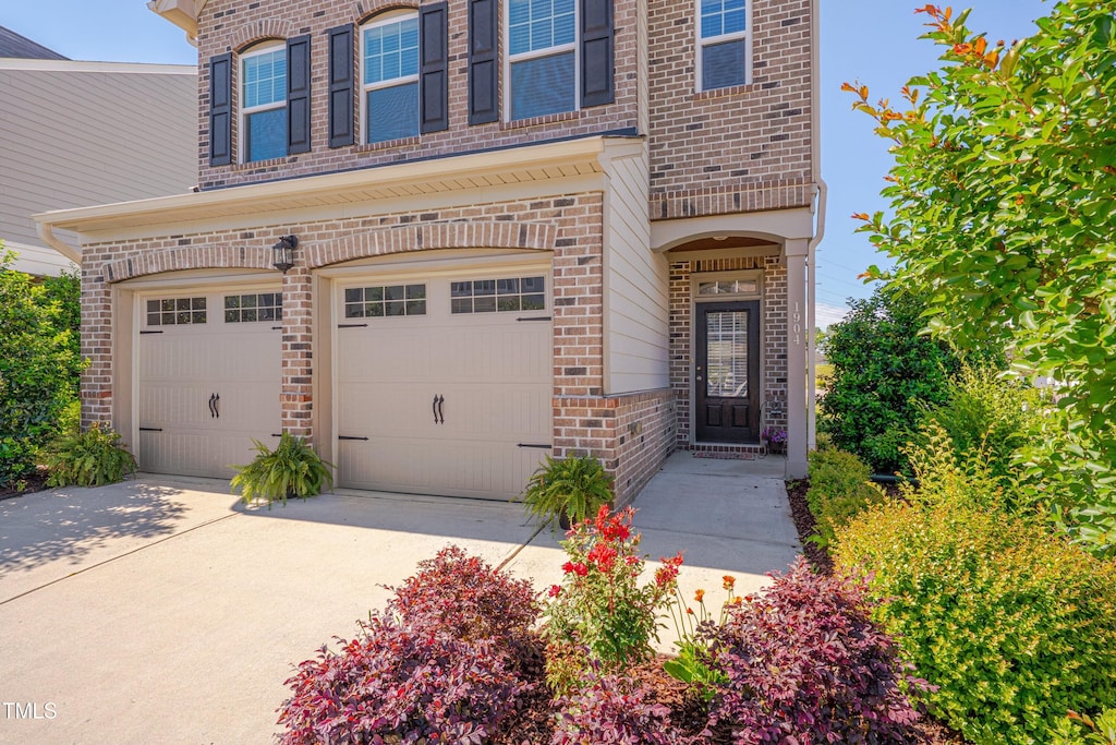 1904 Birdhouse Ln, Wake Forest, NC 27587 - entrance to property with brick siding, an attached garage, and driveway