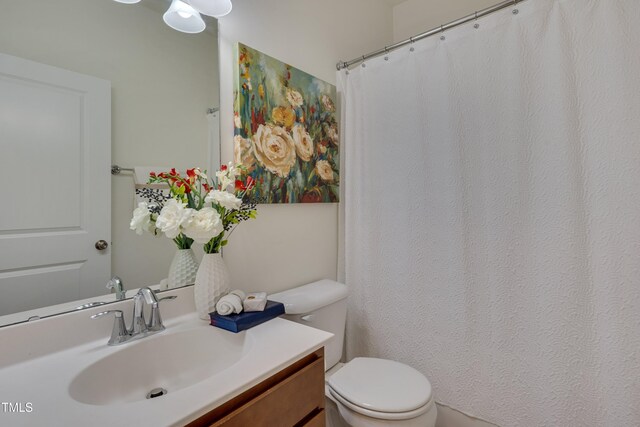 full bathroom featuring toilet and vanity