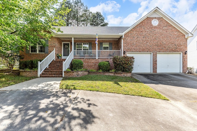 single story home featuring brick siding, asphalt driveway, a porch, and a front yard