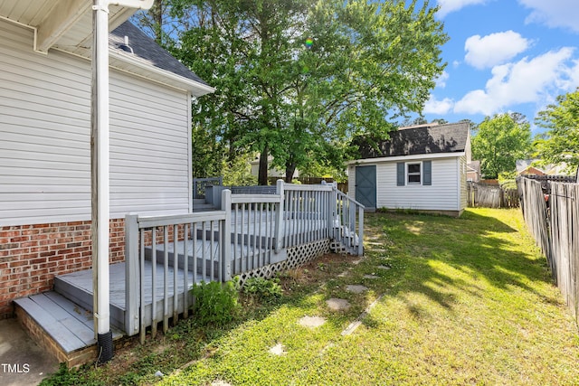 view of yard with a deck, an outdoor structure, and a storage unit