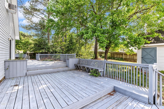 wooden deck featuring cooling unit and fence