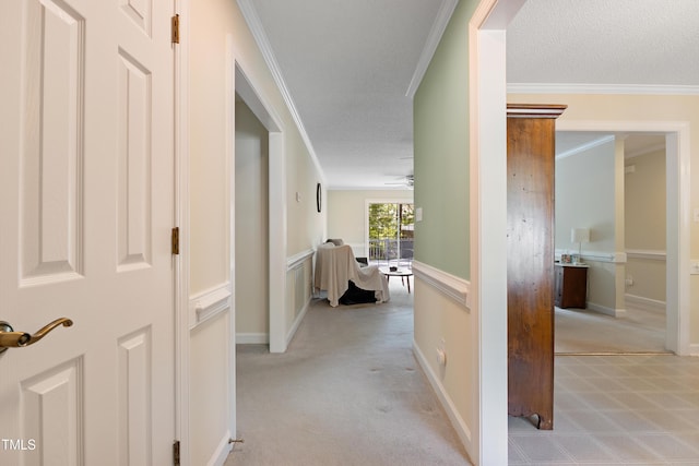 corridor featuring ornamental molding and light colored carpet