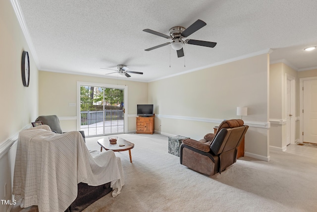 living area with ornamental molding, light colored carpet, a textured ceiling, a ceiling fan, and baseboards