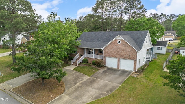 view of front of property with brick siding, driveway, a front lawn, an attached garage, and a porch