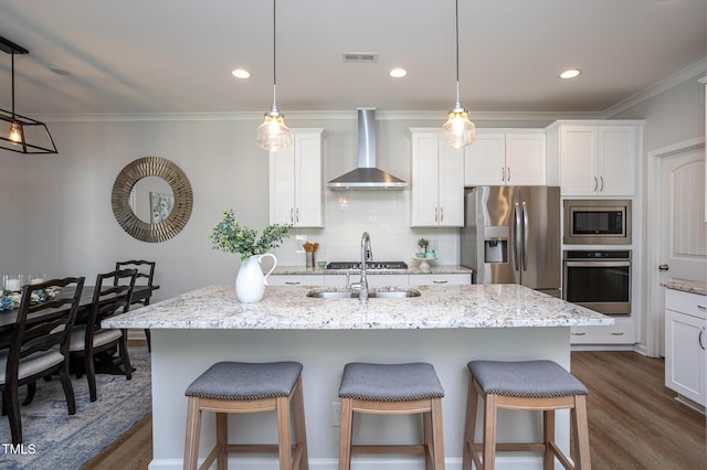 1048 Flagler St, Durham, NC 27713 - kitchen with stainless steel appliances, wall chimney range hood, dark wood-type flooring, a kitchen breakfast bar, and decorative backsplash