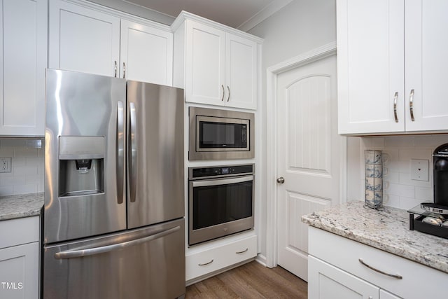 1048 Flagler St, Durham, NC 27713 - kitchen with stainless steel appliances, white cabinetry, and decorative backsplash