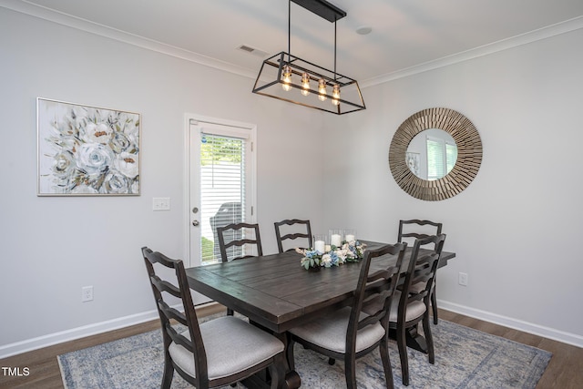 1048 Flagler St, Durham, NC 27713 - dining space with dark wood-style flooring, baseboards, crown molding, and a chandelier