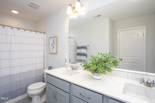 1048 Flagler St, Durham, NC 27713 - full bath with double vanity, toilet, and recessed lighting