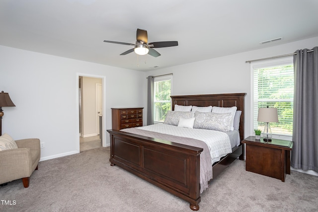 1048 Flagler St, Durham, NC 27713 - bedroom with light carpet, baseboards, and a ceiling fan