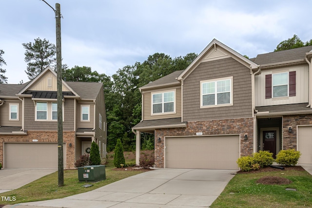 1048 Flagler St, Durham, NC 27713 - view of front of property featuring a garage, concrete driveway, stone siding, and board and batten siding
