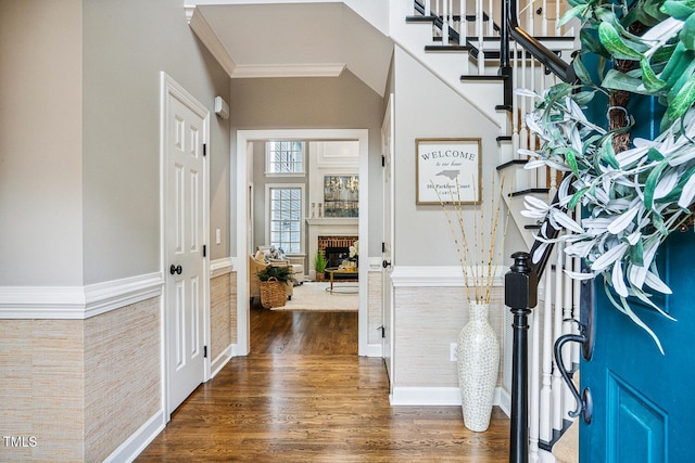 101 Parkbow Ct, Cary, NC 27519 - foyer with wood finished floors, a fireplace, stairs, crown molding, and wainscoting