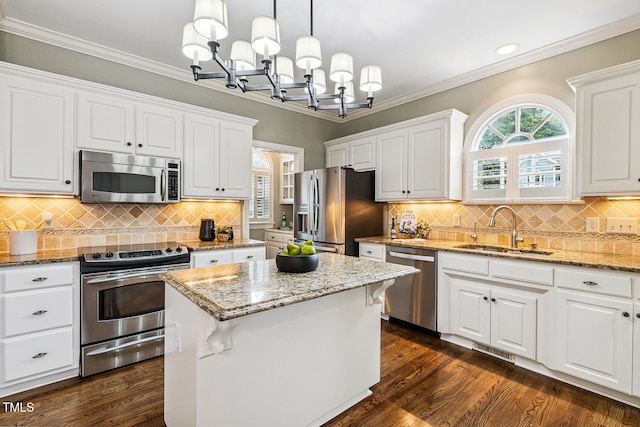 101 Parkbow Ct, Cary, NC 27519 - kitchen with appliances with stainless steel finishes, a chandelier, white cabinets, a center island, and recessed lighting