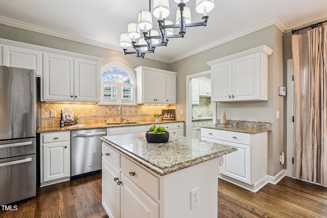 101 Parkbow Ct, Cary, NC 27519 - kitchen with stainless steel appliances, dark wood-style flooring, a chandelier, white cabinetry, and crown molding