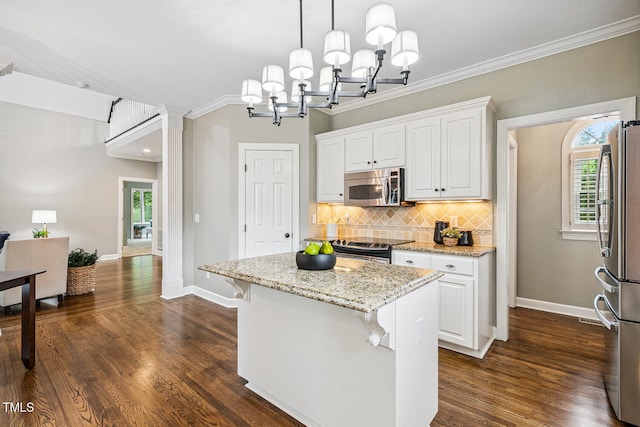101 Parkbow Ct, Cary, NC 27519 - kitchen with stainless steel appliances, white cabinetry, plenty of natural light, backsplash, and ornamental molding