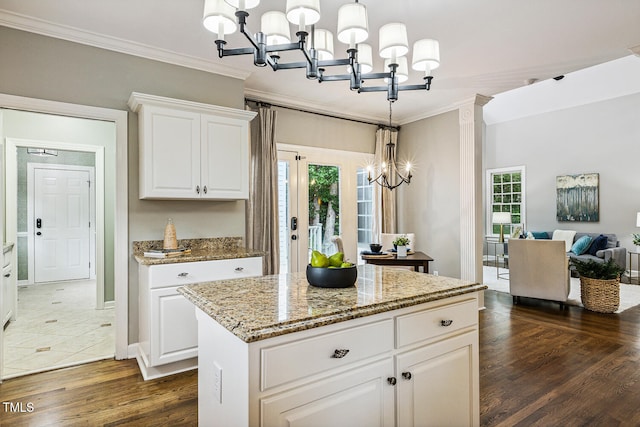 101 Parkbow Ct, Cary, NC 27519 - kitchen with a chandelier, crown molding, dark wood-style flooring, light stone countertops, and healthy amount of natural light