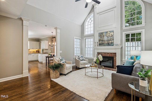 101 Parkbow Ct, Cary, NC 27519 - living room with a brick fireplace, high vaulted ceiling, dark wood-style flooring, a ceiling fan, and a chandelier