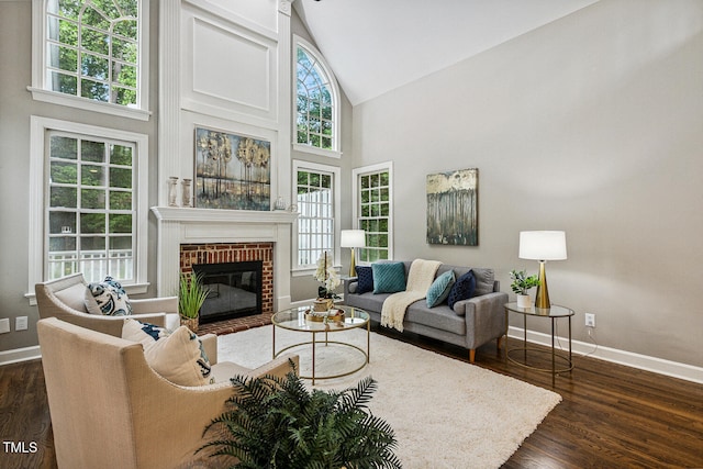 101 Parkbow Ct, Cary, NC 27519 - living area with high vaulted ceiling, a fireplace, and dark wood-type flooring