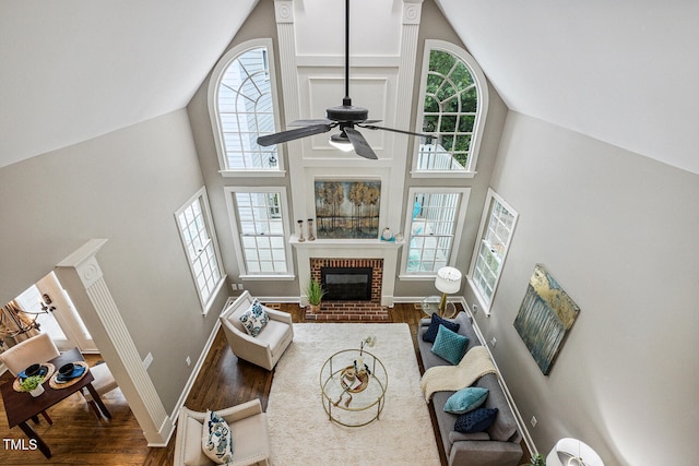 101 Parkbow Ct, Cary, NC 27519 - living area featuring high vaulted ceiling, plenty of natural light, wood finished floors, a fireplace, and ceiling fan