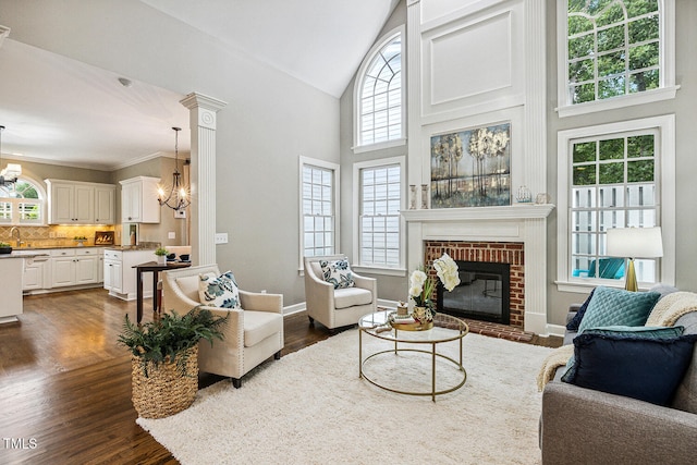 101 Parkbow Ct, Cary, NC 27519 - living room with a chandelier, high vaulted ceiling, a brick fireplace, and dark wood finished floors