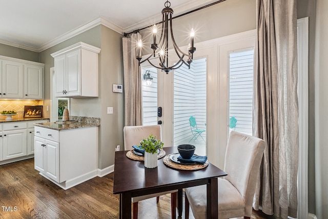 101 Parkbow Ct, Cary, NC 27519 - dining area featuring a chandelier, dark wood-style floors, ornamental molding, and plenty of natural light