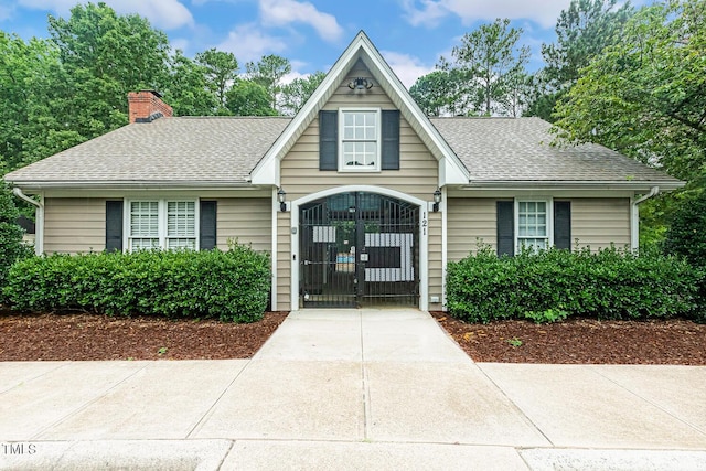 101 Parkbow Ct, Cary, NC 27519 - view of front of home featuring roof with shingles, a gate, and a chimney