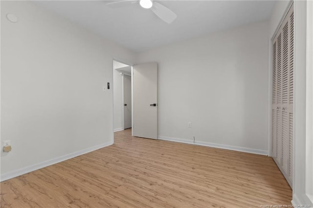 unfurnished bedroom featuring light wood finished floors, baseboards, a closet, and ceiling fan