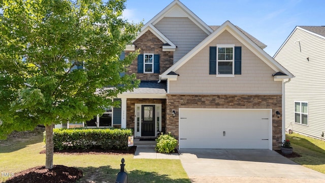 craftsman house with stone siding, concrete driveway, and a front lawn