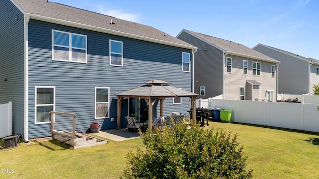 rear view of house featuring a gazebo and a patio