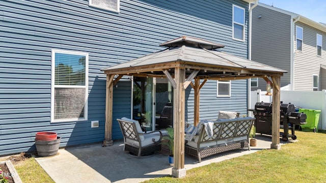 rear view of house featuring a gazebo, a patio, and an outdoor living space