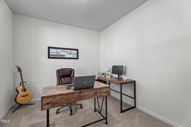 office space featuring light carpet and baseboards