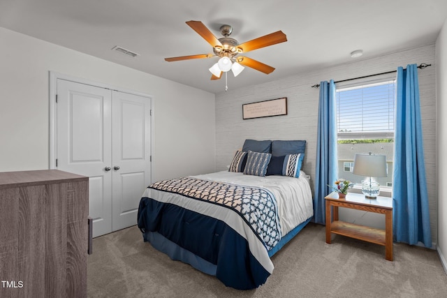 carpeted bedroom with a closet and a ceiling fan