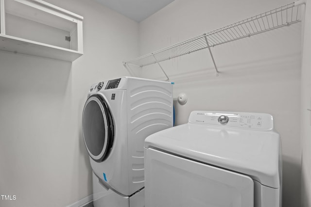 laundry room featuring washing machine and clothes dryer