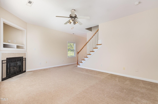 2111 Piney Brook Rd Unit 101, Raleigh, NC 27614 - unfurnished living room with stairway, light colored carpet, ceiling fan, and a fireplace