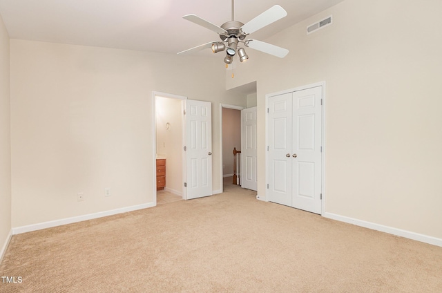 2111 Piney Brook Rd Unit 101, Raleigh, NC 27614 - unfurnished bedroom with light colored carpet, high vaulted ceiling, a closet, connected bathroom, and a ceiling fan