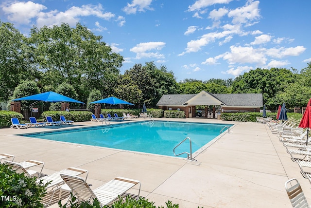 2111 Piney Brook Rd Unit 101, Raleigh, NC 27614 - community pool with a patio and view of wooded area