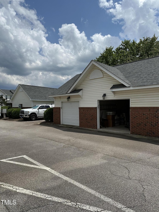 2111 Piney Brook Rd Unit 101, Raleigh, NC 27614 - view of side of property with brick siding and a shingled roof