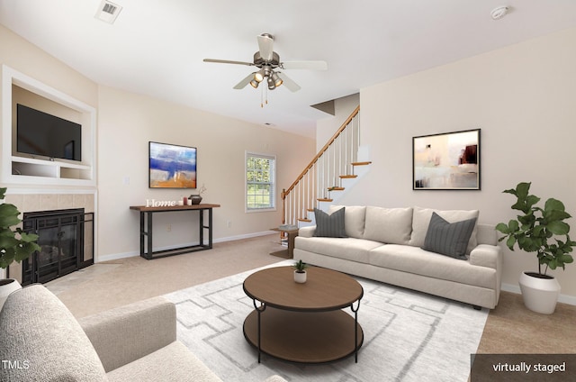 2111 Piney Brook Rd Unit 101, Raleigh, NC 27614 - carpeted living room with a ceiling fan, stairs, and a tiled fireplace
