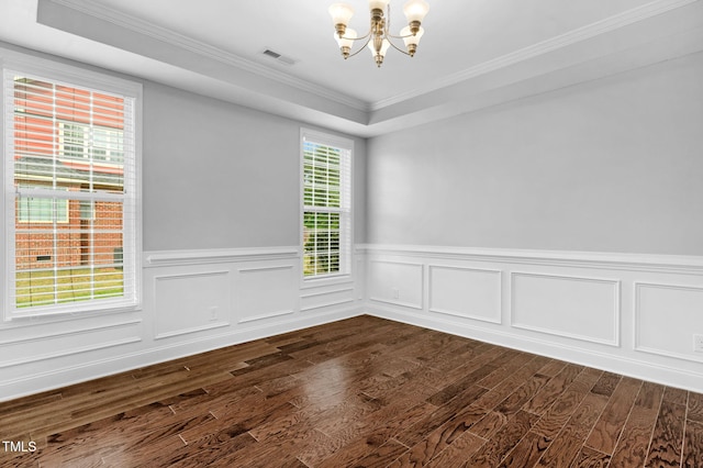 2808 Sand Trap Ln, Hope Mills, NC 28348 - spare room with a chandelier, dark wood-type flooring, a wainscoted wall, ornamental molding, and a raised ceiling